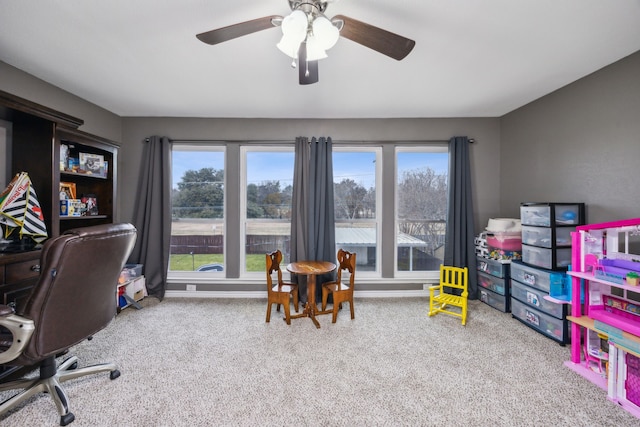 rec room with light carpet, ceiling fan, and a healthy amount of sunlight