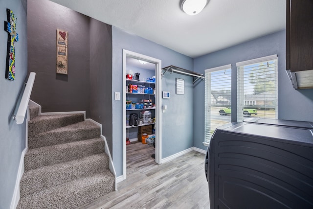 laundry room with light hardwood / wood-style floors and washer and dryer