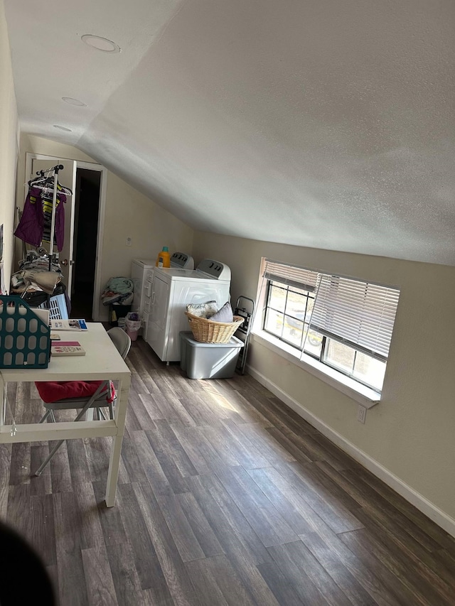 bonus room featuring lofted ceiling, washer and clothes dryer, wood finished floors, and baseboards