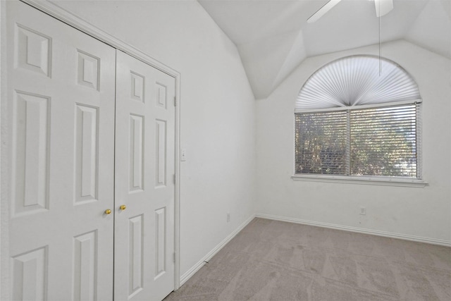 carpeted spare room with lofted ceiling