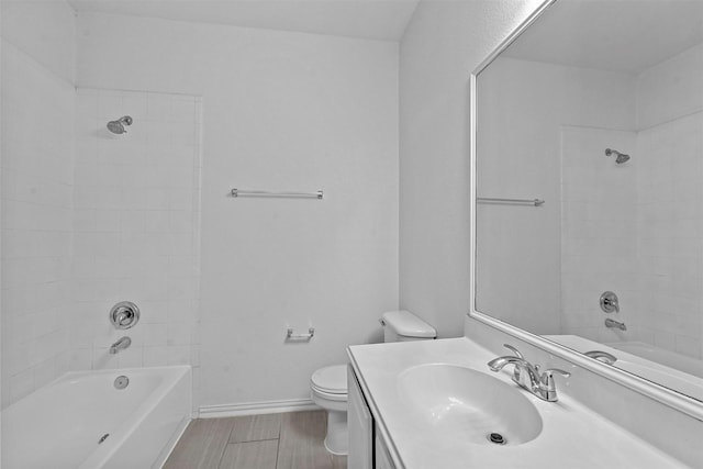 full bathroom with vanity, toilet, and tiled shower / bath