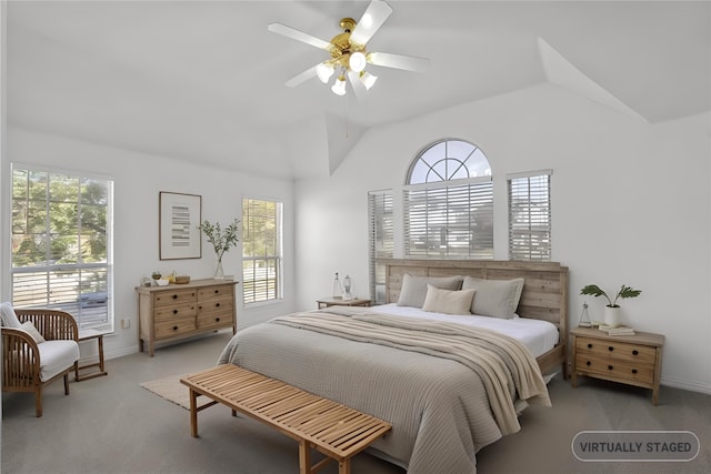 bedroom with ceiling fan, lofted ceiling, and light carpet