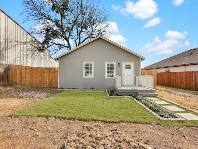 rear view of house with a yard