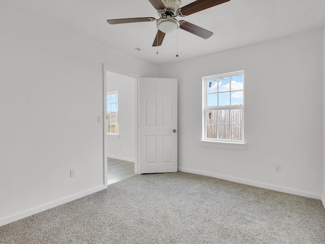 spare room featuring ceiling fan and carpet flooring