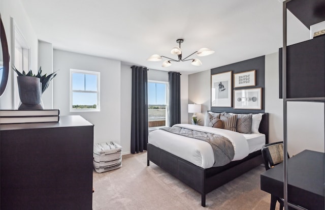 carpeted bedroom with a chandelier