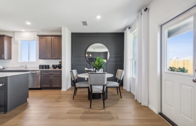 dining space featuring a healthy amount of sunlight and light wood-type flooring