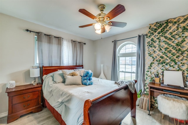 bedroom with ceiling fan and light hardwood / wood-style flooring