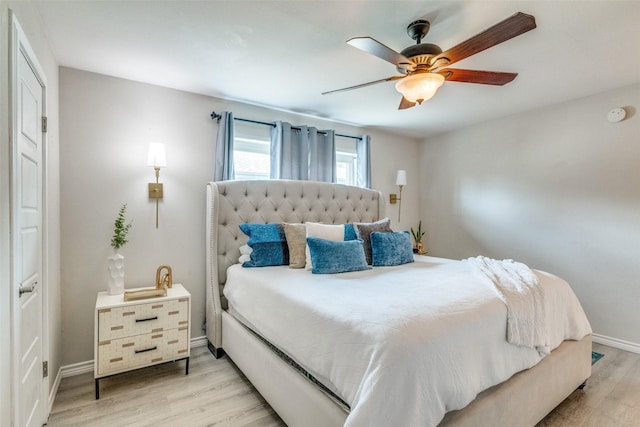 bedroom with light hardwood / wood-style floors and ceiling fan