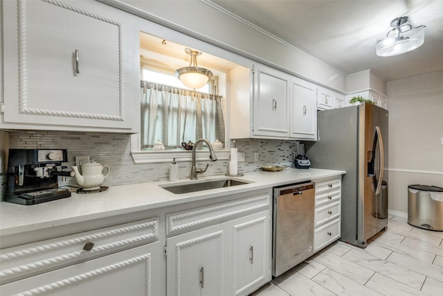 kitchen featuring sink, decorative backsplash, white cabinets, and appliances with stainless steel finishes