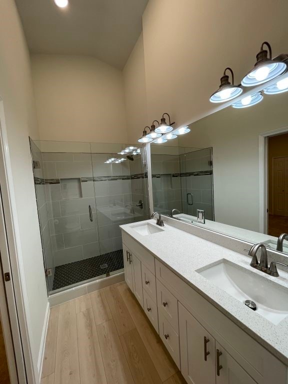 bathroom featuring vanity, a shower with door, and hardwood / wood-style floors