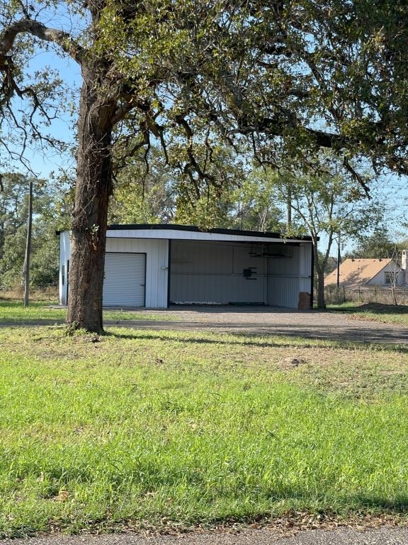 view of outbuilding with a garage and a lawn