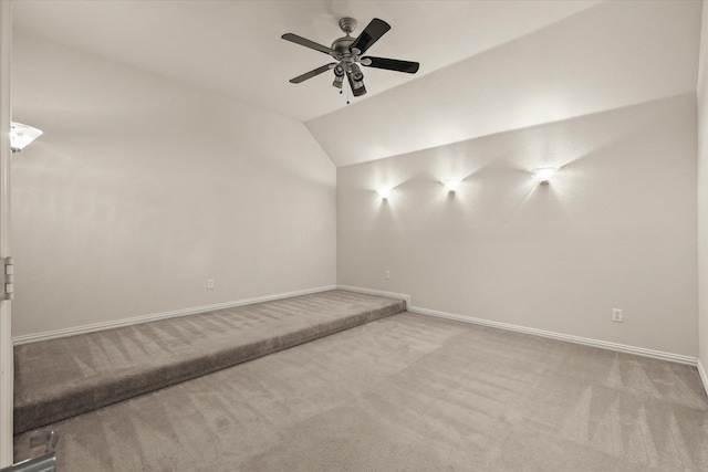 unfurnished room featuring lofted ceiling, light colored carpet, and ceiling fan