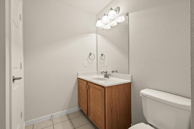 bathroom with vanity, tile patterned floors, and toilet