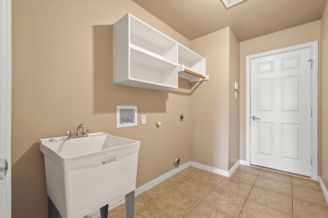 laundry area with gas dryer hookup, sink, washer hookup, light tile patterned floors, and electric dryer hookup