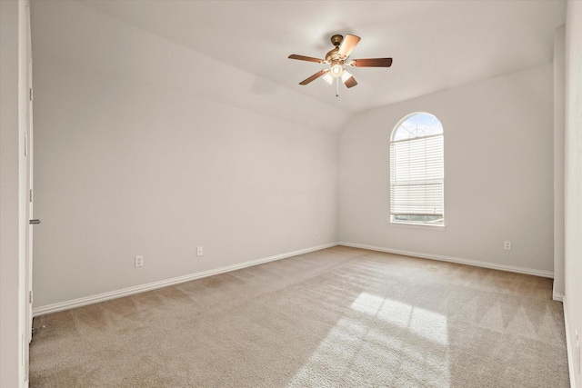 unfurnished room with ceiling fan, light colored carpet, and lofted ceiling