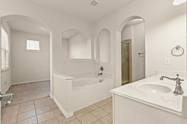 bathroom featuring tile patterned flooring, vanity, and separate shower and tub