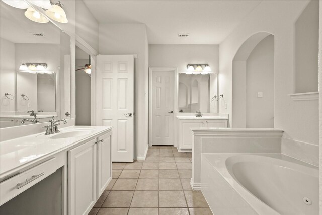 bathroom featuring vanity, a bath, tile patterned floors, and ceiling fan