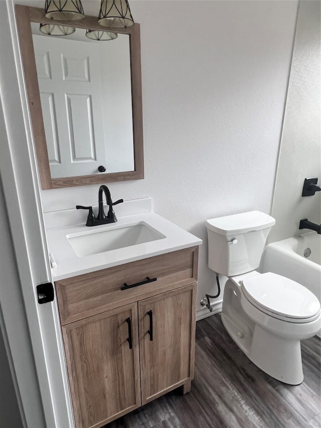 full bathroom with vanity, toilet, bathing tub / shower combination, and wood-type flooring