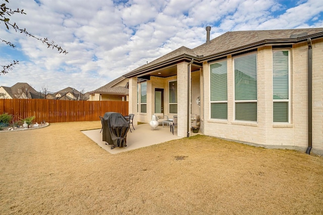 rear view of property featuring a patio