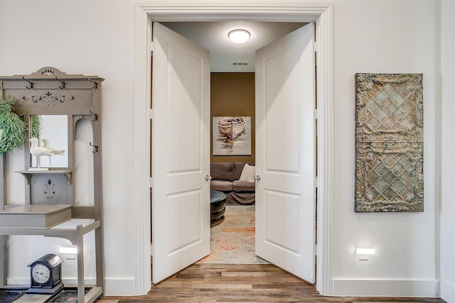 corridor featuring hardwood / wood-style flooring