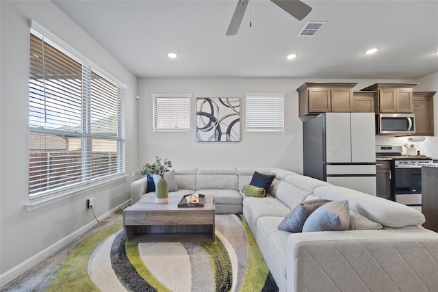 carpeted living room featuring ceiling fan