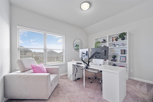 carpeted home office featuring vaulted ceiling