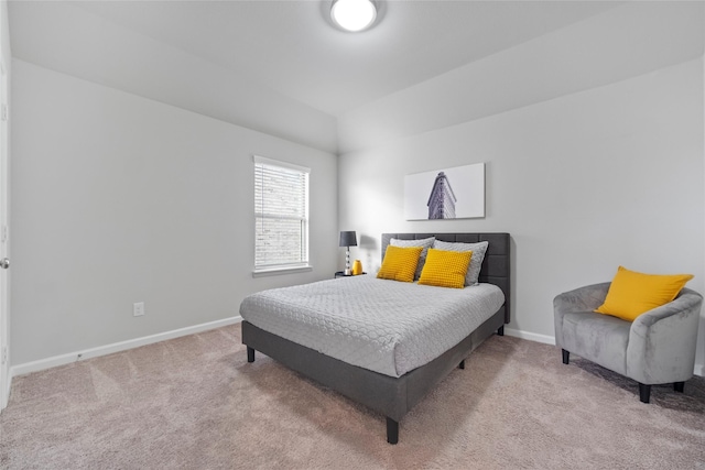 bedroom featuring lofted ceiling and light colored carpet