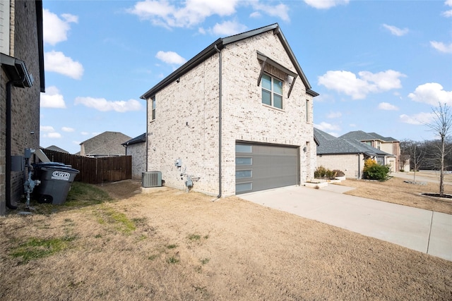 view of home's exterior featuring a garage and central air condition unit