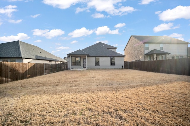 rear view of property with a lawn