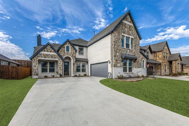 tudor home with a garage and a front lawn