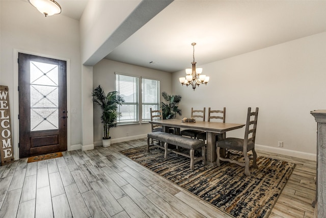 dining room featuring an inviting chandelier and light hardwood / wood-style flooring