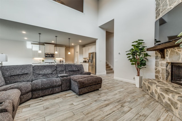 living room with a stone fireplace