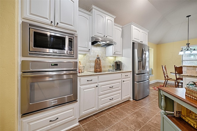 kitchen with pendant lighting, lofted ceiling, white cabinets, stainless steel appliances, and light stone countertops