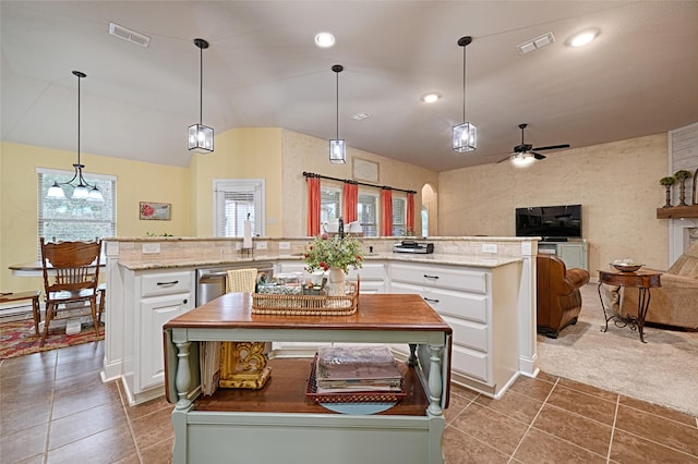 kitchen with decorative light fixtures, a center island, white cabinets, and carpet flooring