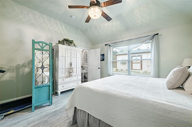 bedroom featuring lofted ceiling, hardwood / wood-style floors, and ceiling fan