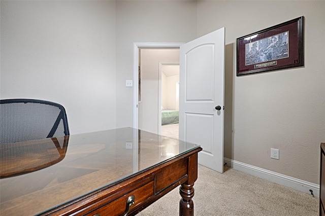 office featuring baseboards and light colored carpet