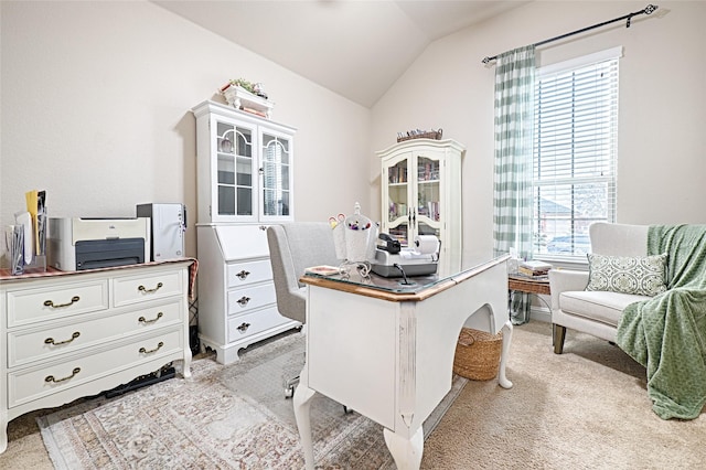 office with vaulted ceiling and light colored carpet