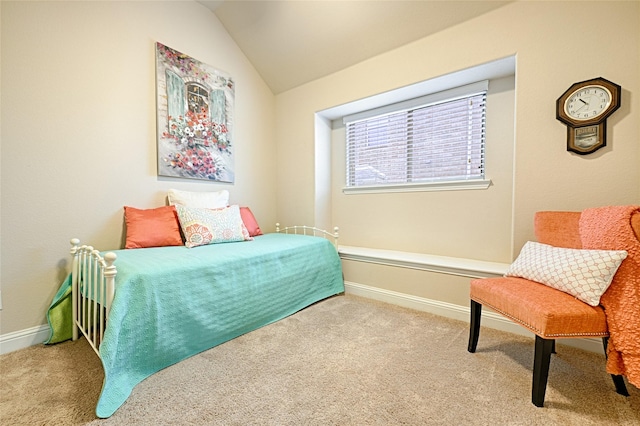 carpeted bedroom with baseboards and vaulted ceiling