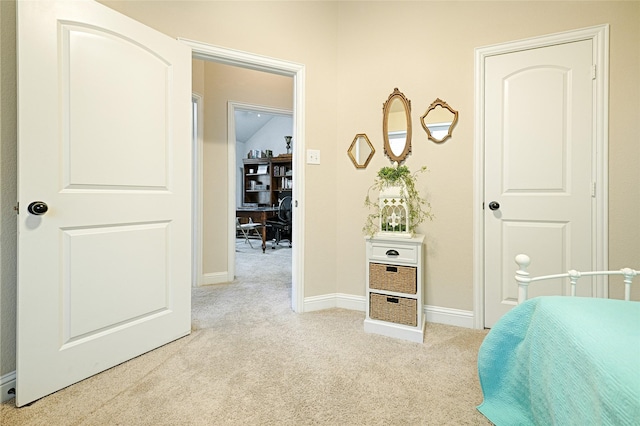 bedroom with light carpet and baseboards