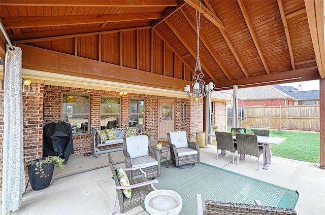 view of patio with grilling area, fence, and outdoor dining area