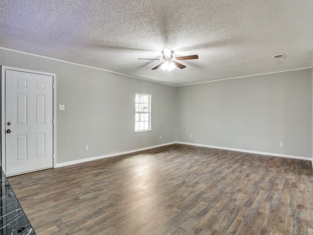 empty room with crown molding, ceiling fan, dark hardwood / wood-style flooring, and a textured ceiling