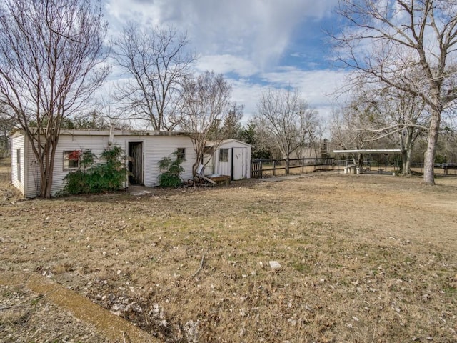 view of yard with a carport and a storage shed