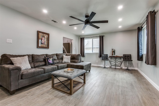 living room with ceiling fan and light hardwood / wood-style floors