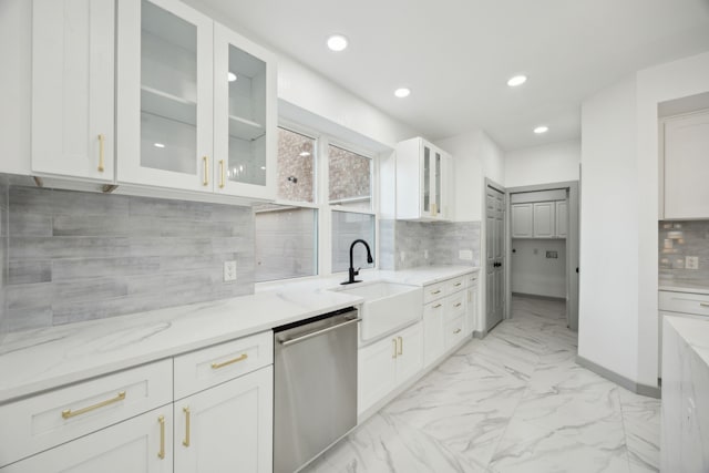 kitchen with sink, white cabinets, decorative backsplash, stainless steel dishwasher, and light stone counters