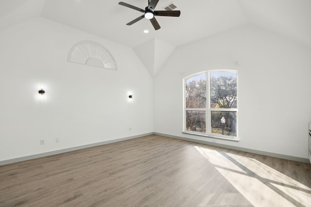 spare room with vaulted ceiling, ceiling fan, and light hardwood / wood-style flooring