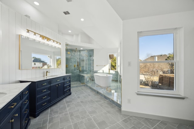 bathroom with vaulted ceiling, vanity, and separate shower and tub