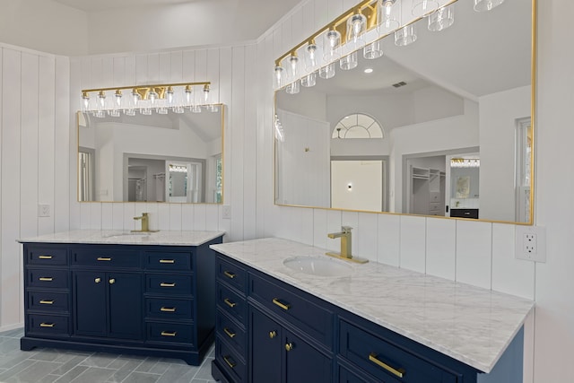 bathroom with tasteful backsplash, vanity, and vaulted ceiling