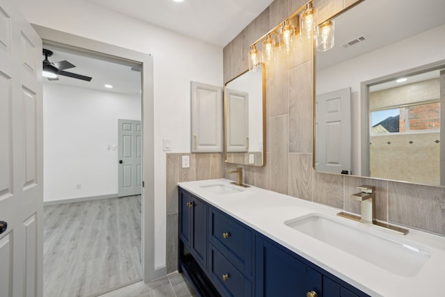 bathroom with ceiling fan, vanity, and hardwood / wood-style floors