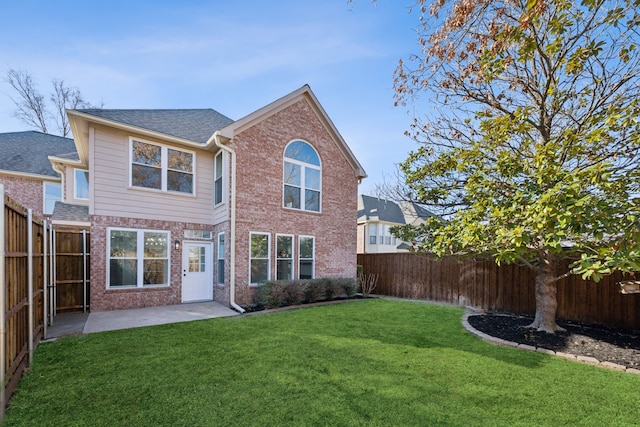 rear view of house with a patio area and a lawn