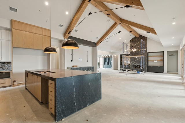 kitchen with high vaulted ceiling, hanging light fixtures, beamed ceiling, a large island, and decorative backsplash